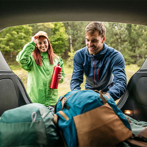 couple packing their car with hiking gear