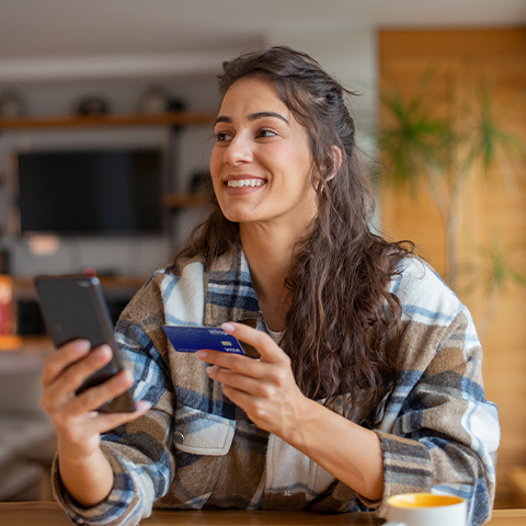 woman holding her wings card and cell phone_480x480